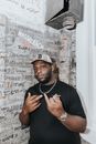 Man in Black Crew Neck T-shirt Wearing Gray Fitted Cap