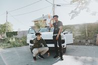 Man and Woman Sitting on White Car