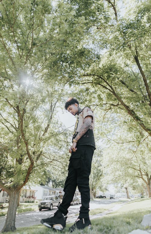 Man Standing under Trees