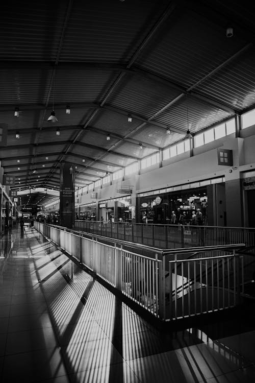 Grayscale Photo of  Shadows in Shopping Mall