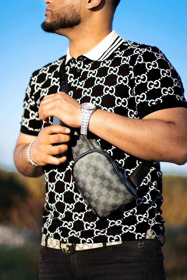 Man In Black And White Shirt With Cross Body Bag 