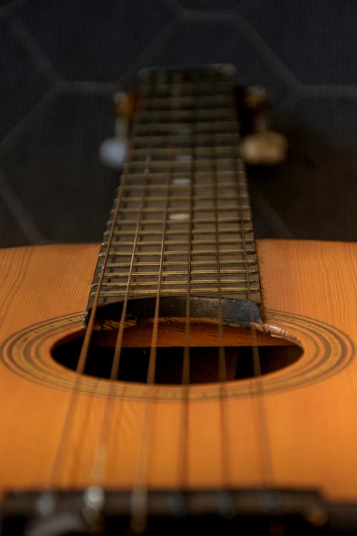 Brown Acoustic Guitar in Close Up Photography