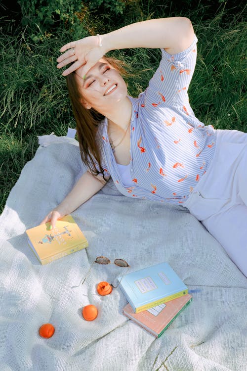 
A Woman Lying Down on a Picnic Blanket