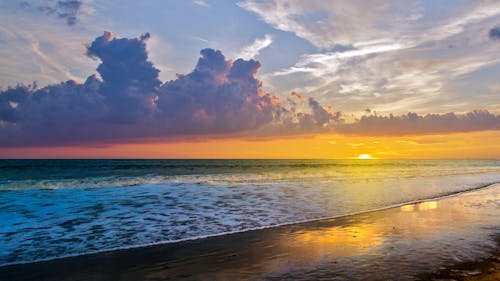 Sea Waves Crashing on Shore during Sunset