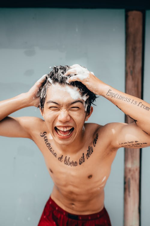 Free Shirtless Man Washing His Hair Stock Photo