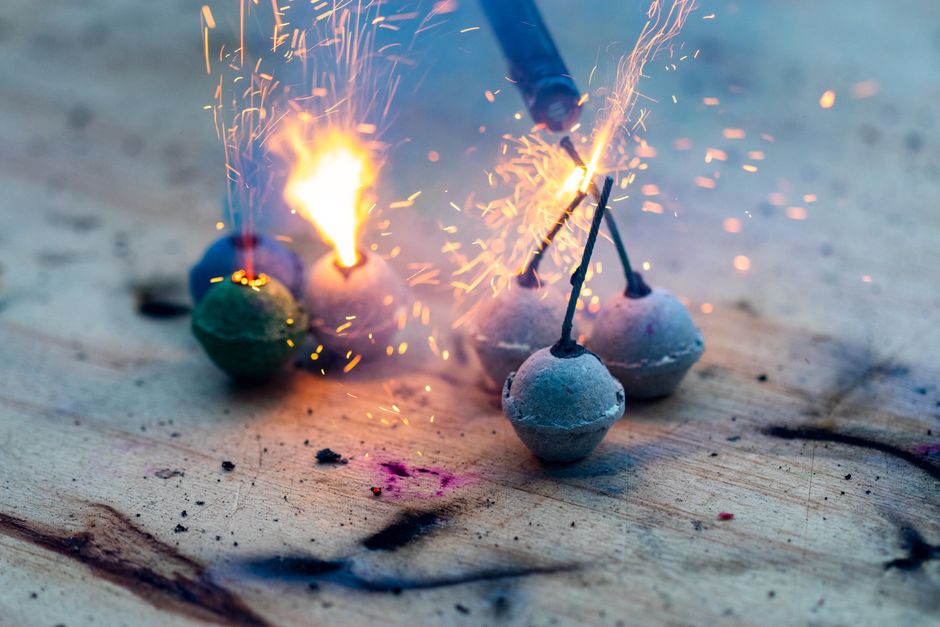 From above sparkling glowing Bengal candles with bright sparks burning on weathered wooden surface