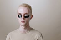 Man in White Crew Neck Shirt Wearing Black Sunglasses