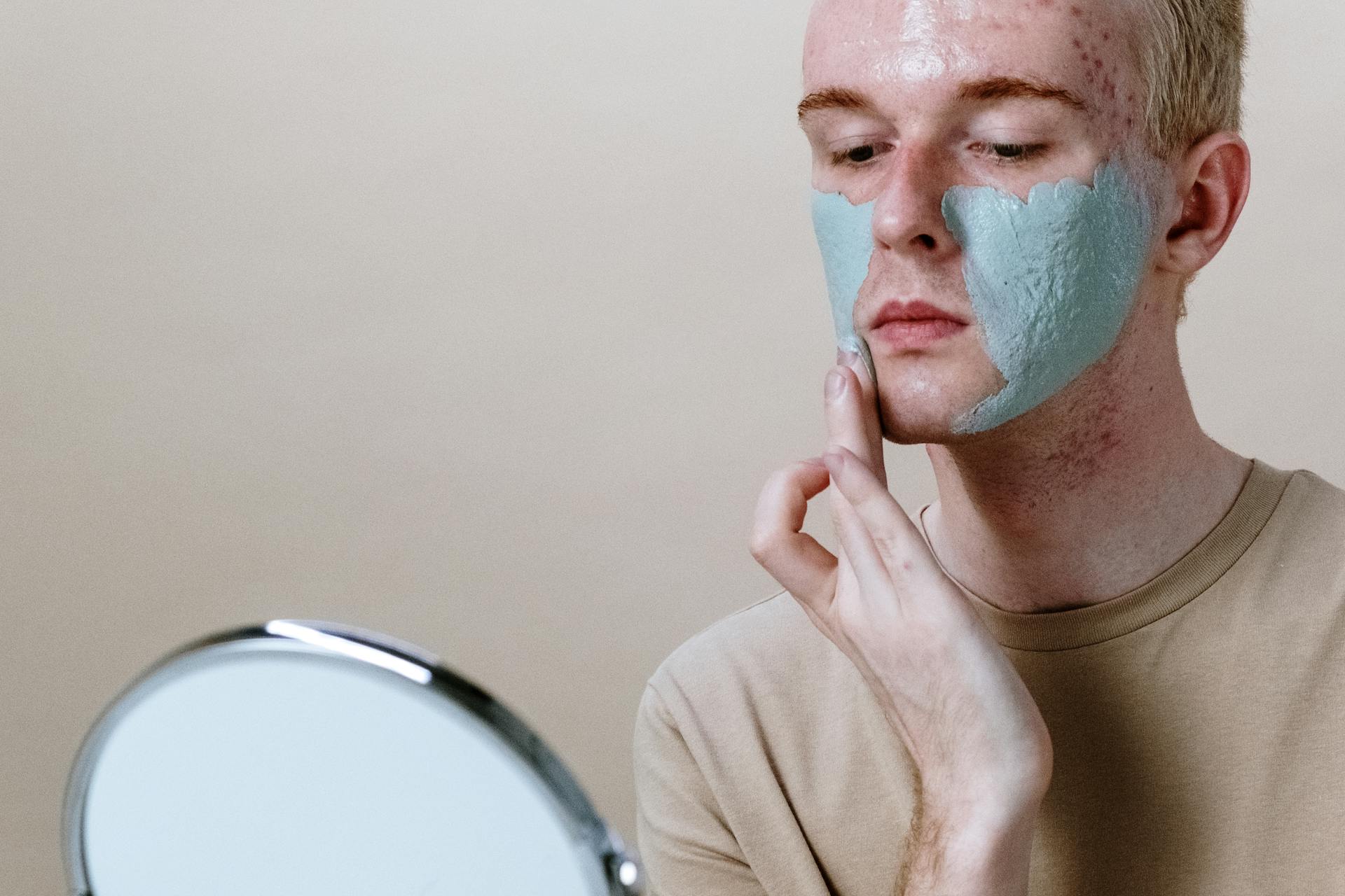 Man in Gray Crew Neck Shirt With Green Powder on Face