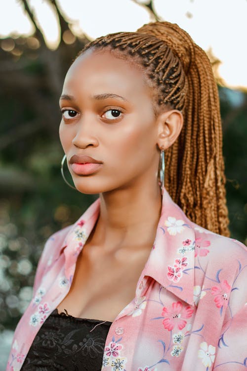 Thoughtful black woman with pigtails and earrings