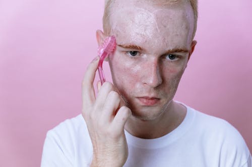 Man in White Crew Neck Shirt With Pink Plastic Hair Clip