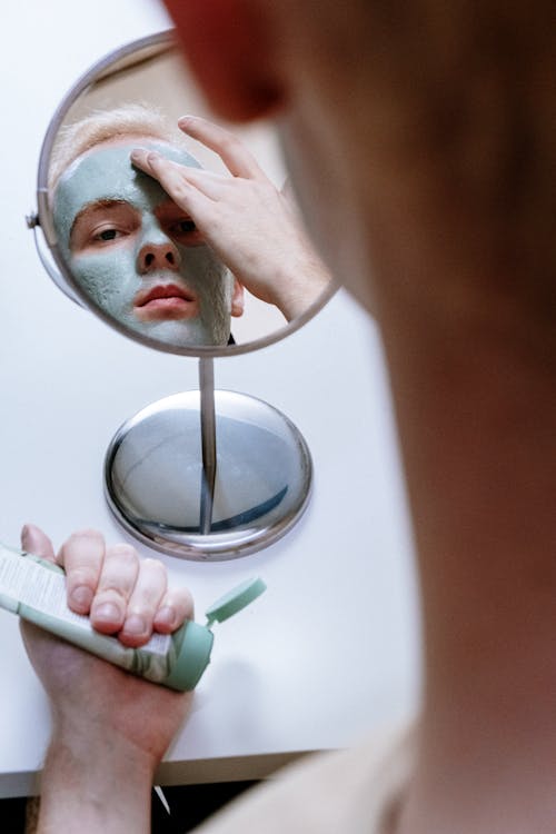 Person Holding Magnifying Glass With Green Liquid