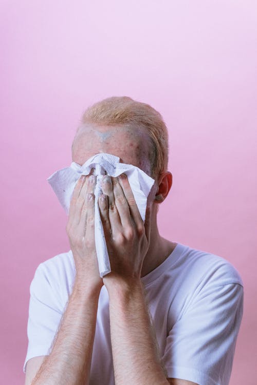 Free Man in White Crew Neck T-shirt Covering His Face With White Textile Stock Photo