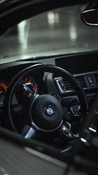 Explore the modern luxury of a BMW car interior featuring a sleek dashboard and steering wheel.