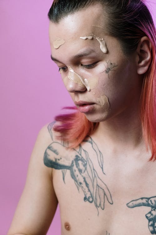 Woman With Black and Blue Dragon Tattoo on Her Face