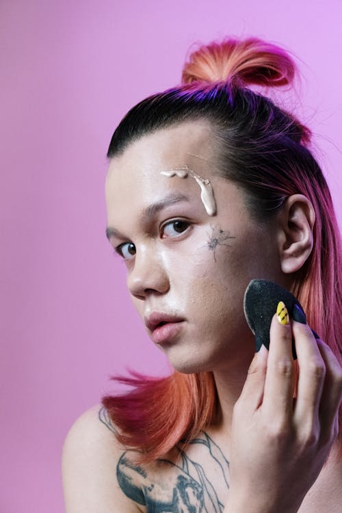 Woman in Pink Shirt Holding Her Face