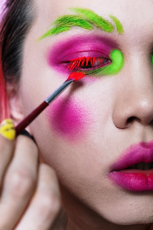 Woman With Pink Lipstick and Yellow and Red Eyeshadow