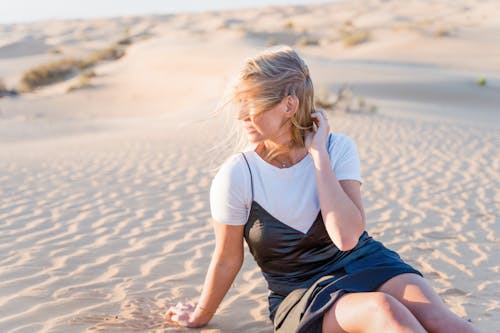 

A Woman Sitting on the Sand