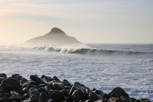 View Of Surfable Wave and Island In The Middle Of The Sea