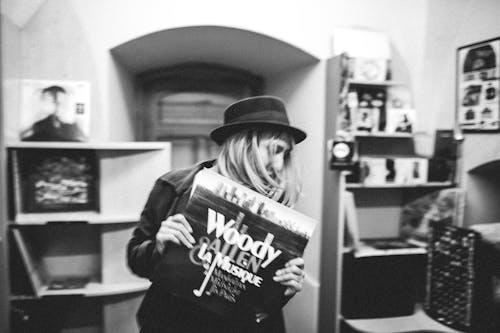 Free Woman Wearing a Hat Holding a Music Record Stock Photo