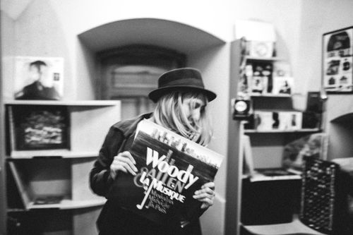 Free A woman holding a vintage vinyl record in a classic black and white setting. Stock Photo