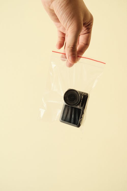 Black Camera on White Plastic Bag