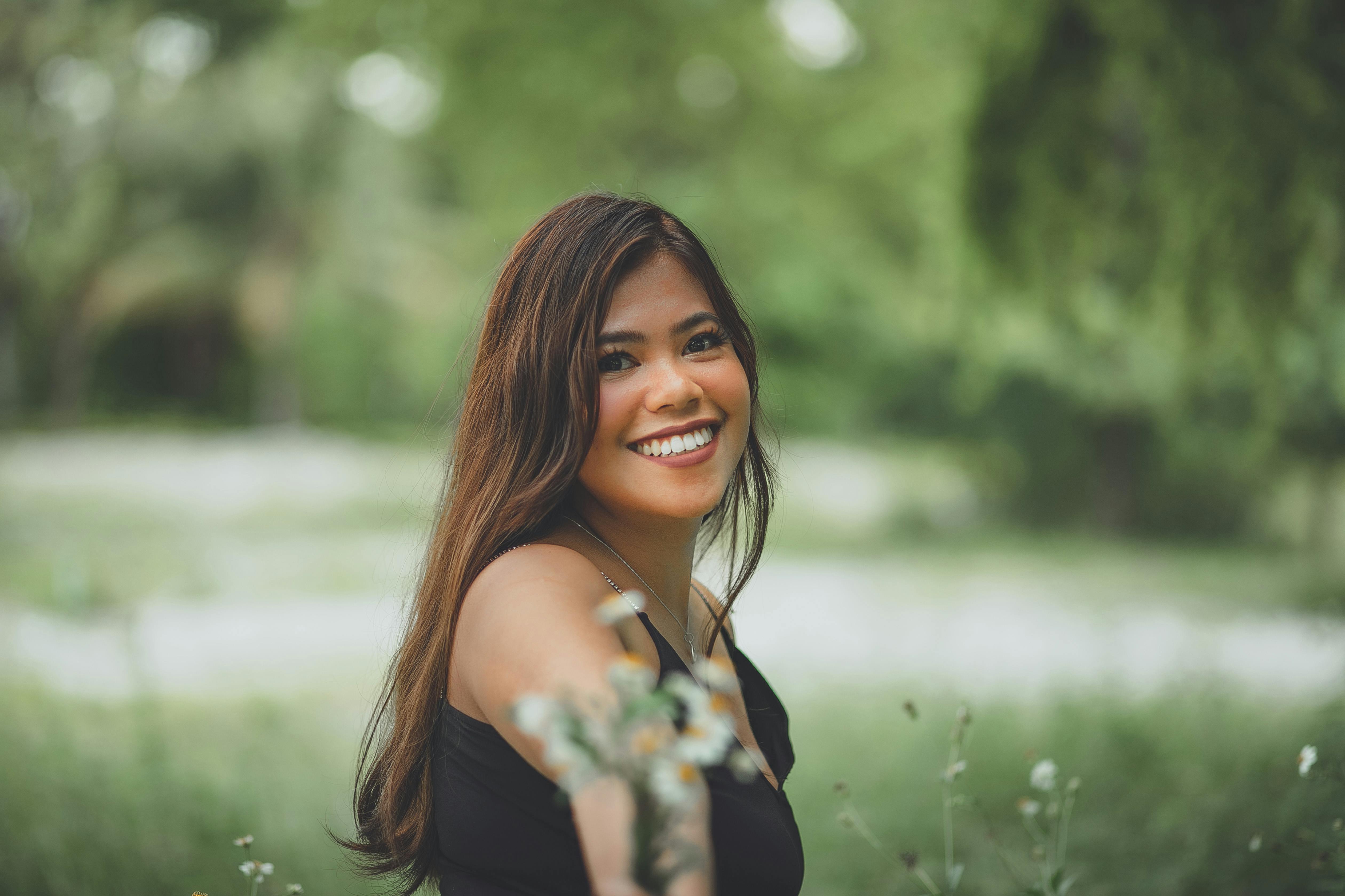 Smiling ethnic gardener with plant on sunny day · Free Stock Photo