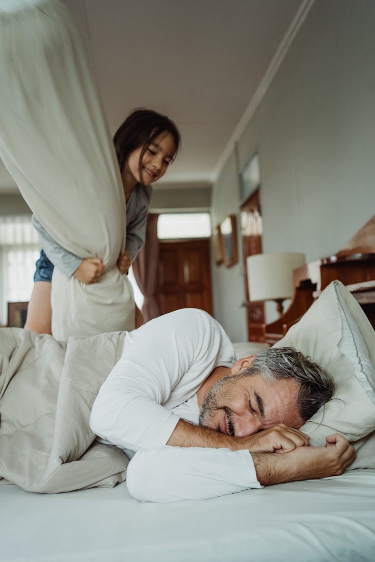 Man In White Long Sleeve Shirt Lying On Bed