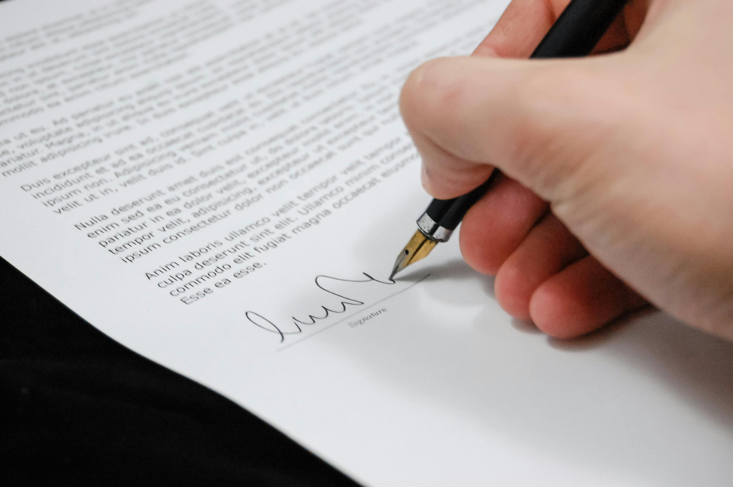 Person Signing in Documentation Paper · Free Stock Photo