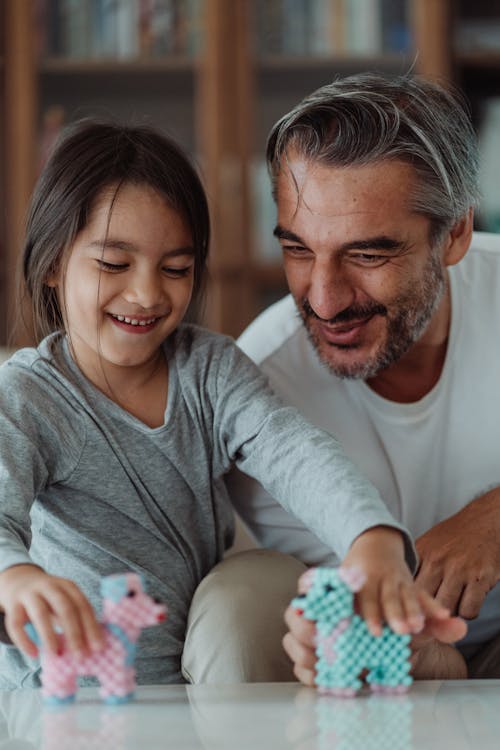 Free A Happy Girl Playing Small Dog Toys  Stock Photo