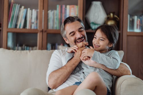 A Man Giving Chocolate Stick to his Daughter