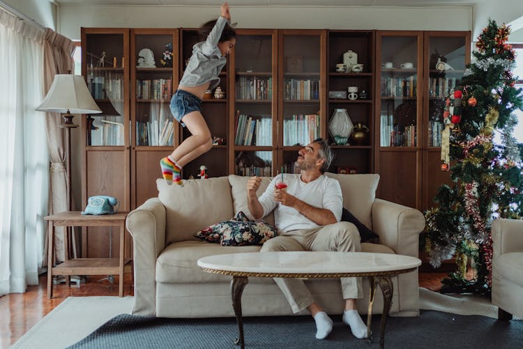 A Girl Jumping On The Couch