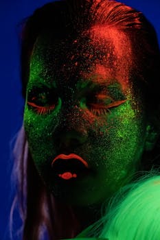 Striking portrait with ethereal neon makeup in vibrant UV light.