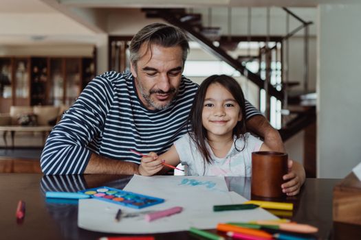 Smiling Girl Sitting Beside a Bearded Man