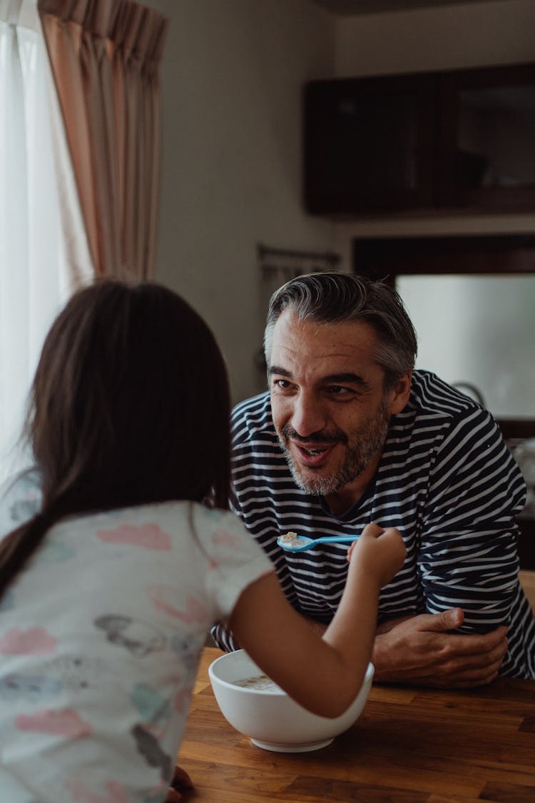 Father And Daughter Eating Cereal 