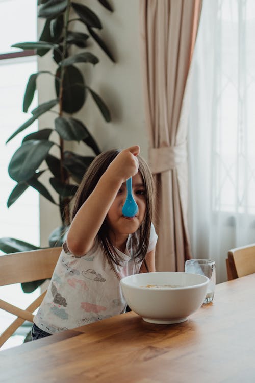 A Little Girl Eating Breakfast