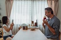 Little Girl Making Photo of Father and Cupcake