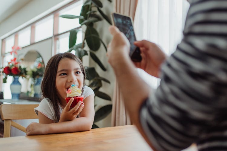 Taking Photo Of Girl Eating Cake