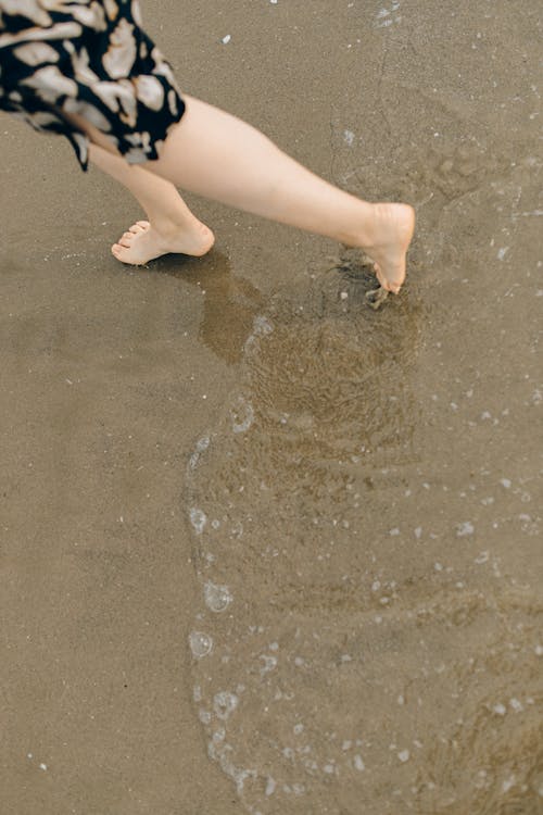 
A Person Walking on a Shore
