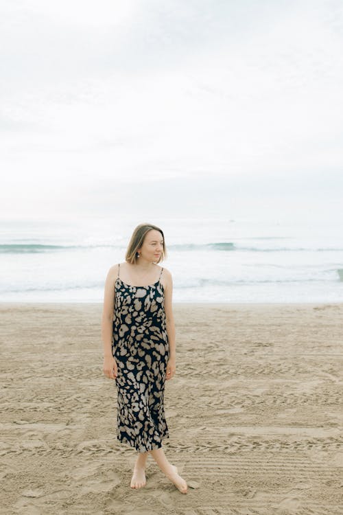 A Woman Wearing a Spaghetti Strap Dress on a Beach