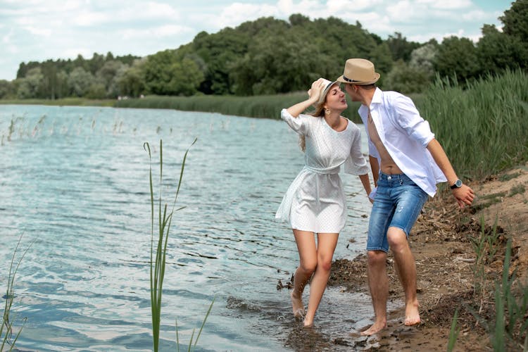 A Couple Walking By The Lake