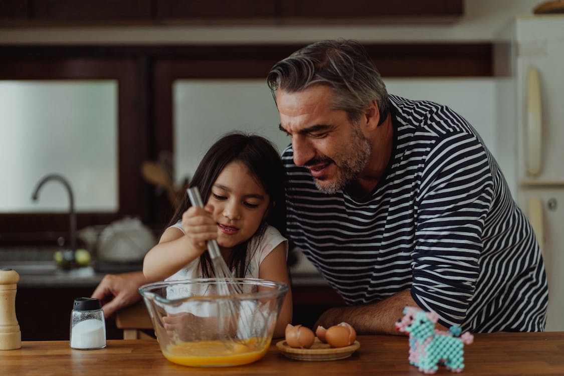Free Father and Daughter Cooking Together Stock Photo