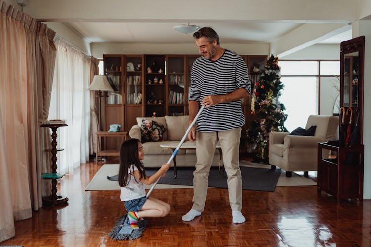 Happy Father And Daughter Cleaning House