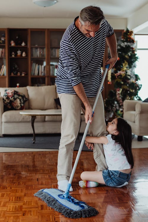 Free A Father Cleaning the Floor Stock Photo