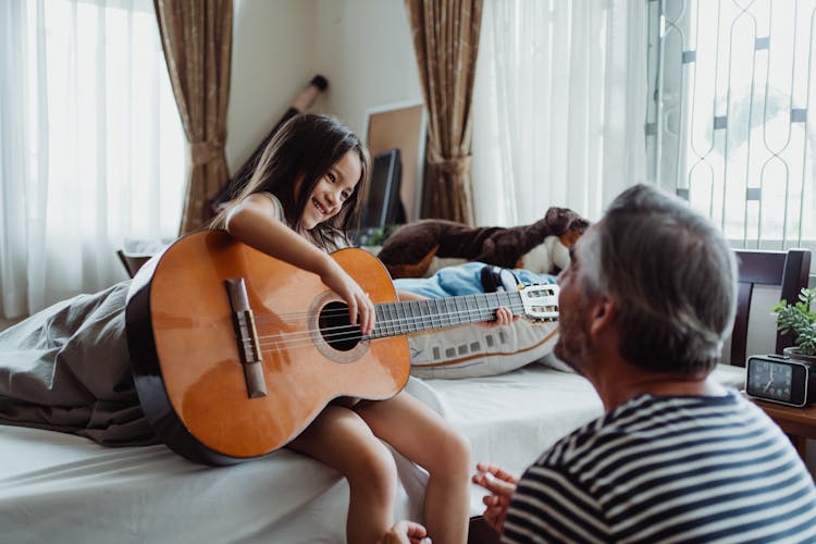 Girl Playing Guitar For Her Dad