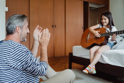 Girl Playing Guitar for Her Dad