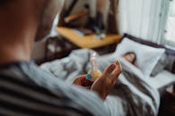 Person Holding White Plastic Bottle