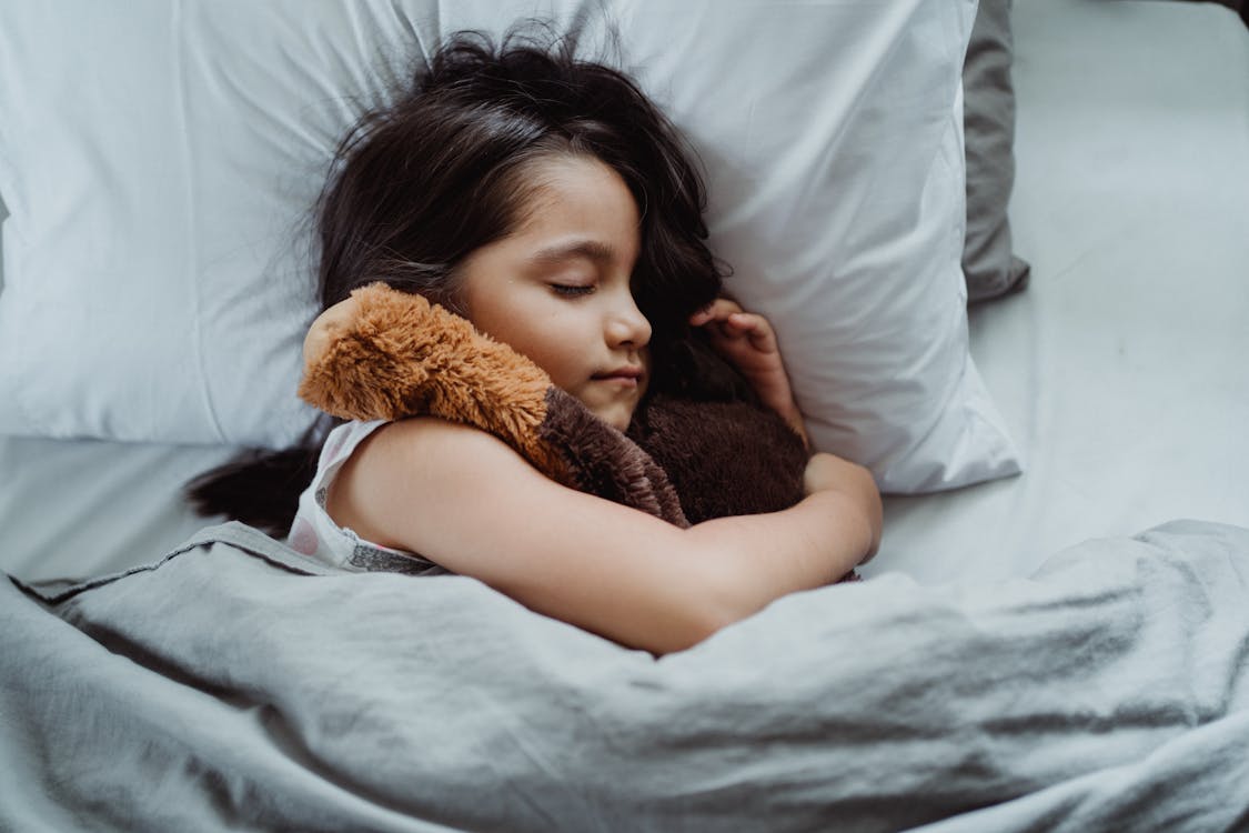 Free Girl Lying on Bed Sleeping Stock Photo