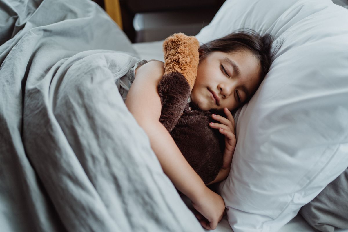 Young child in pajamas settling into a cozy bedtime routine