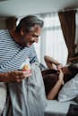 Father Waking up His Daughter with a Birthday Cupcake 