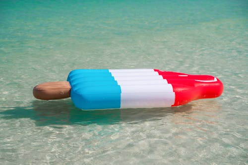 Red Blue and White Inflatable on Water
